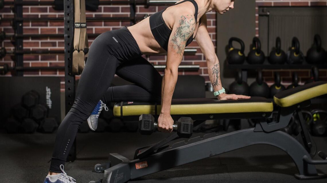 Woman Displaying Dumbbell Exercise